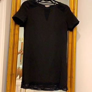 Black mini dress with fishnet accents